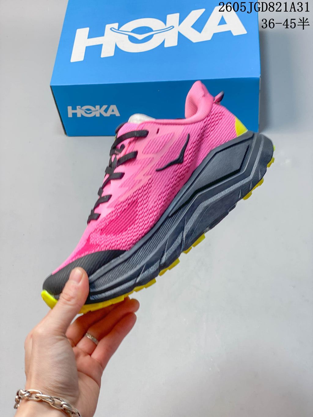 Side profile of the pink Challenger 8 shoe with dark midsole and yellow outsole accents.