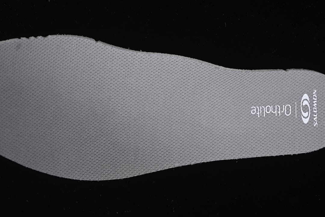 Gray Salomon Ortholite-branded insole shown from above.