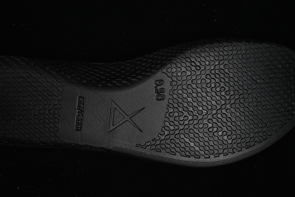 Close-up of patterned black outsole with Kobe branding