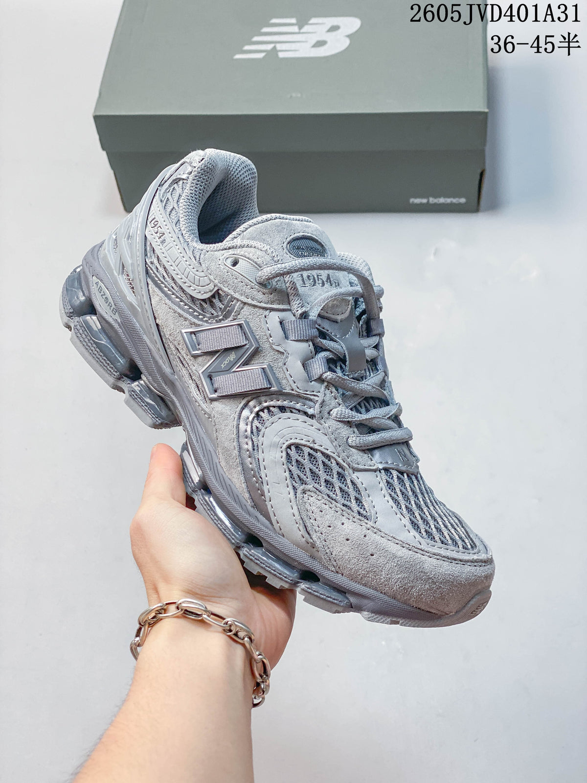 Light gray New Balance 997 sneaker showing the side and layered upper