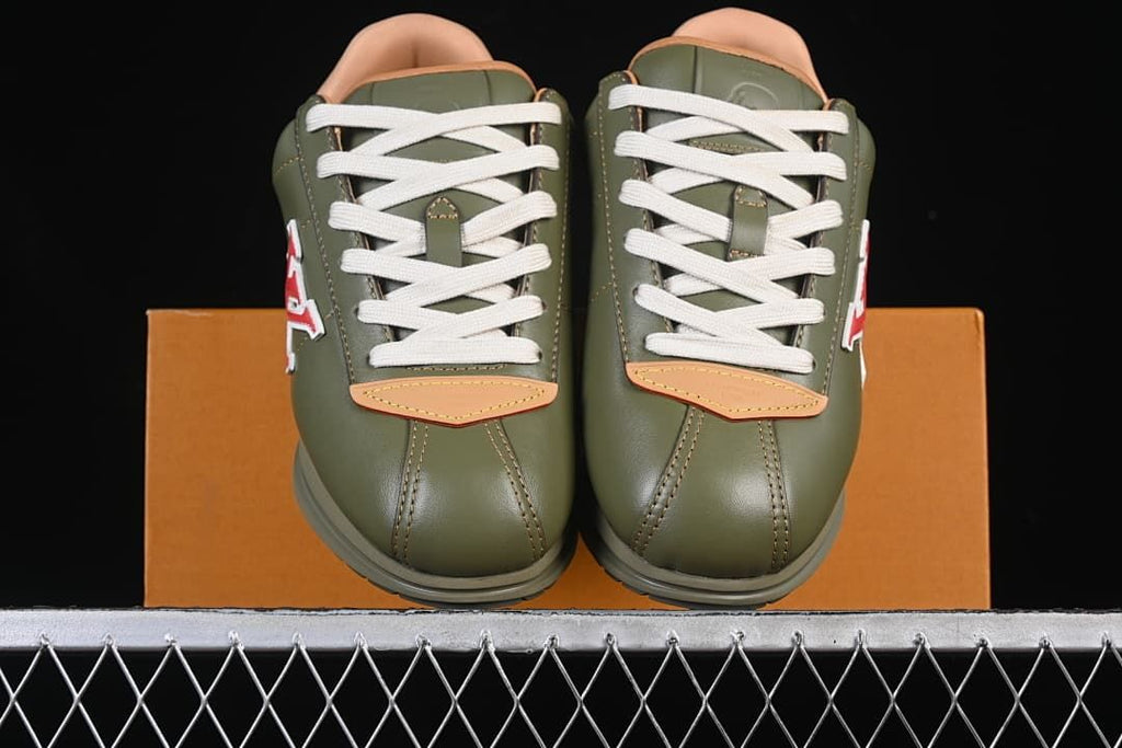 Front view of the pair showing cream laces and tan toe accents