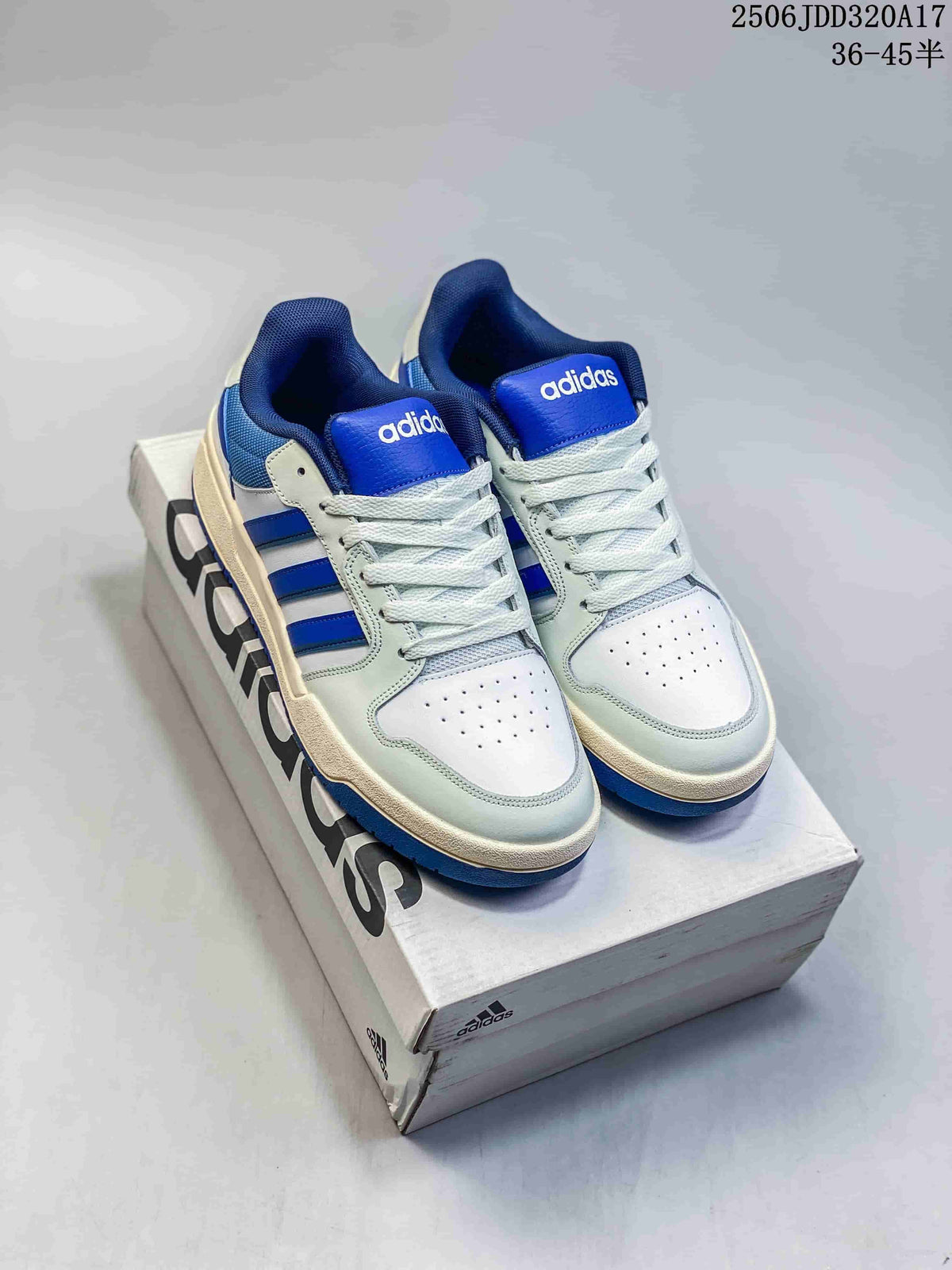 Pair of white and royal-blue adidas Entrap sneakers displayed on a shoebox
