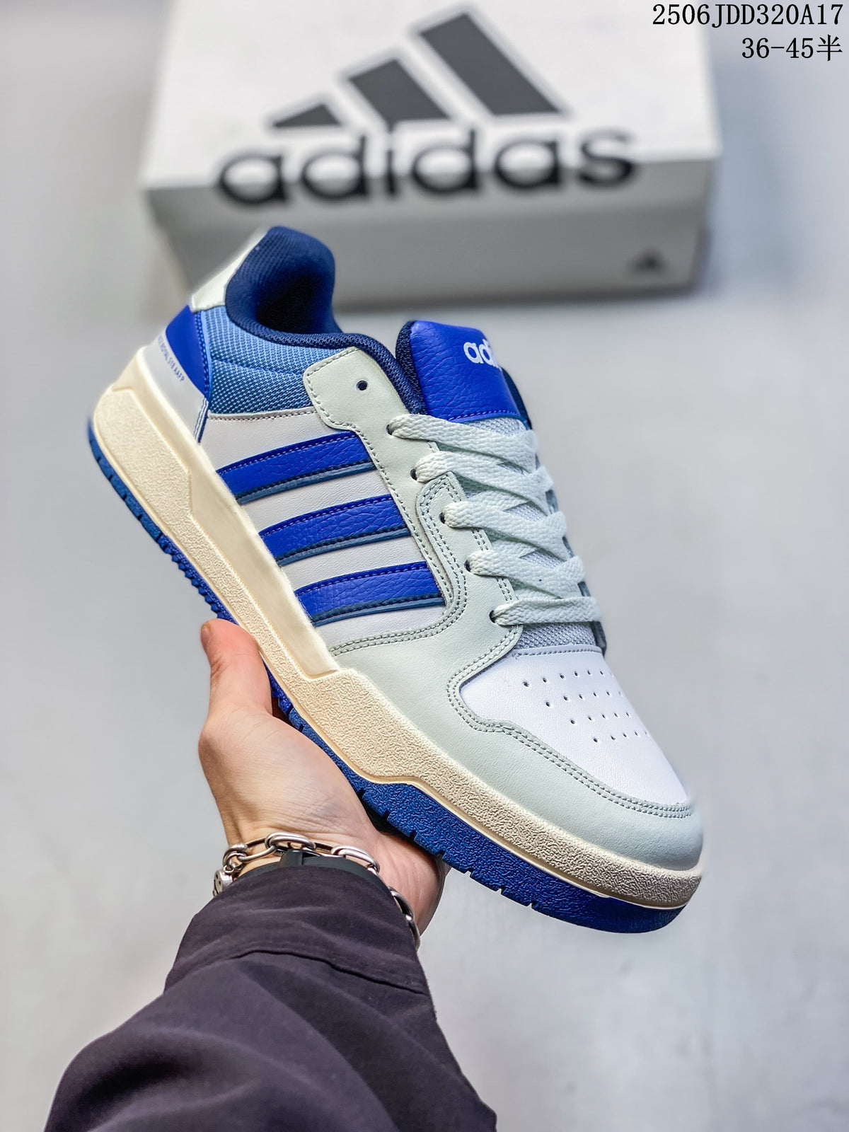 Angled side view of the white and royal blue adidas Entrap sneaker