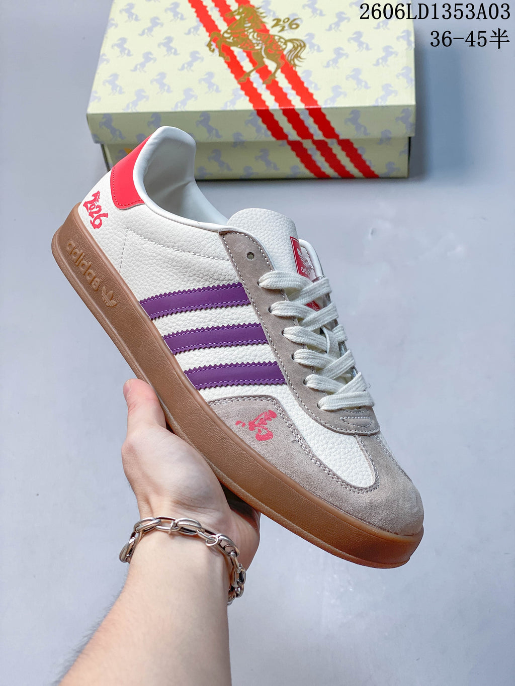 White Gazelle Indoor sneaker with purple stripes, taupe panels, and a brown outsole.