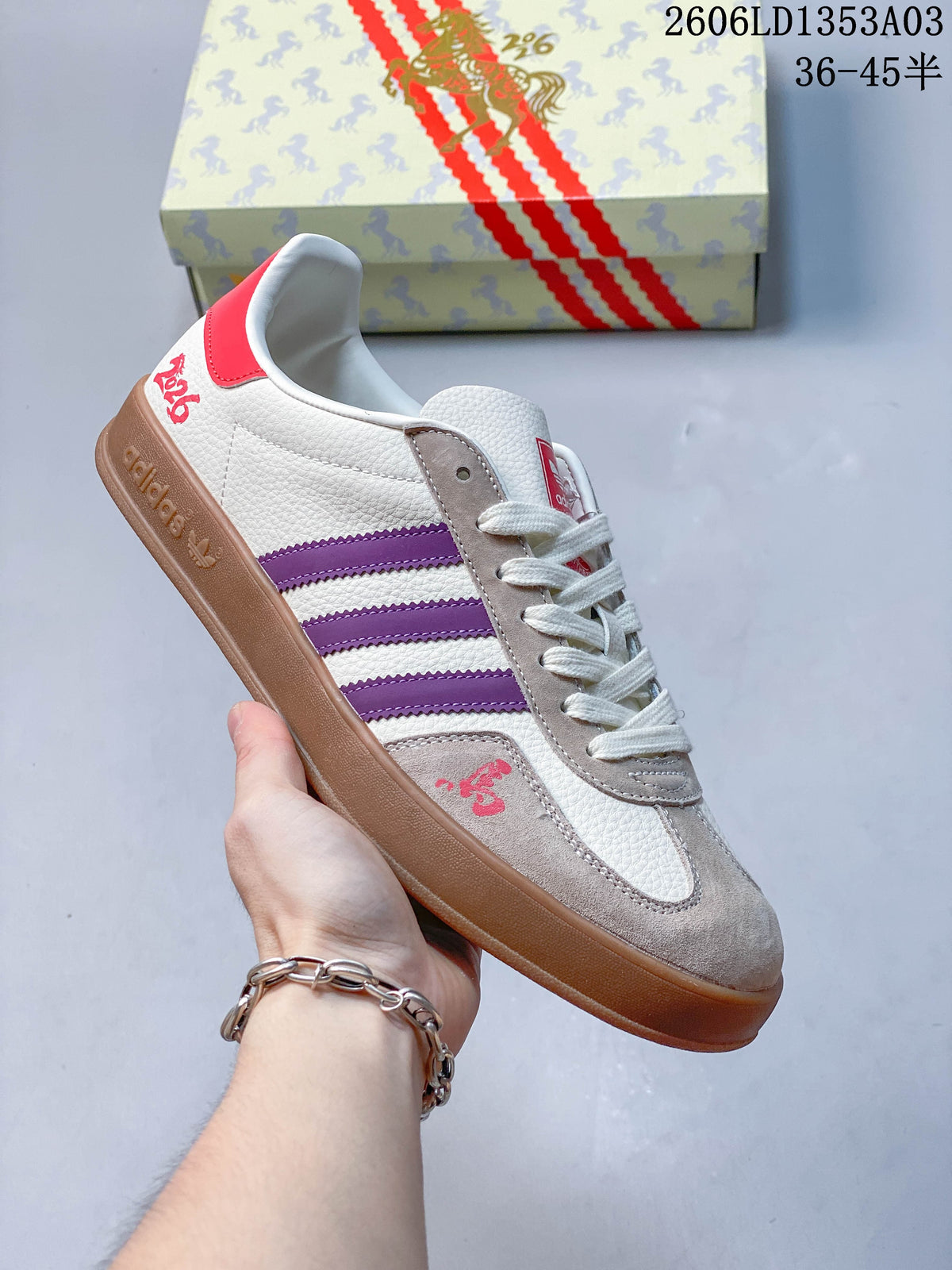 White Gazelle Indoor sneaker with purple stripes, taupe panels, and a brown outsole.