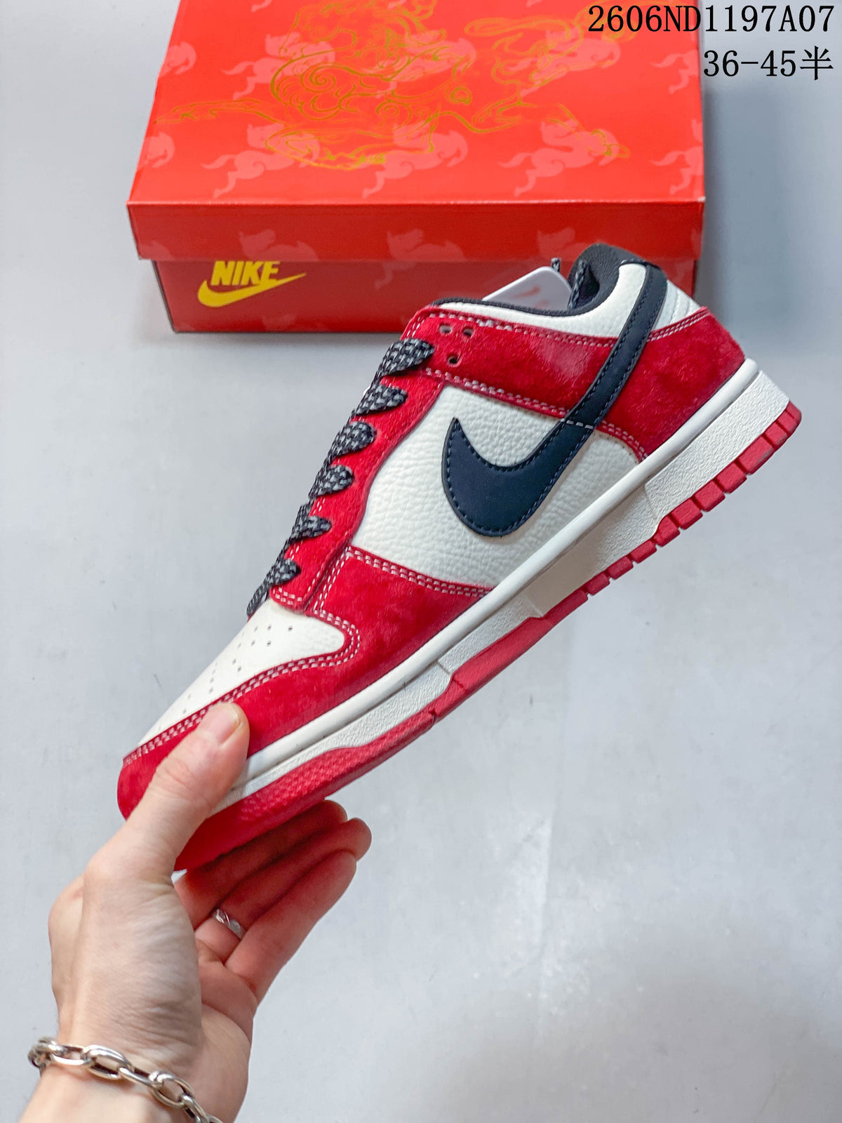 Side view of the low-top sneaker with a navy Swoosh and red overlays