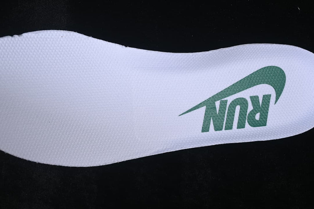 Close-up of the insole with green Nike branding
