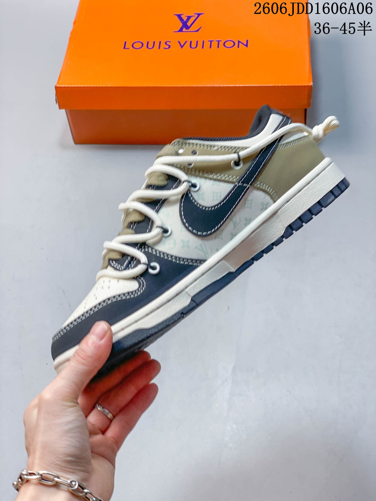 Side view of a cream and navy Nike SB Dunk Low sneaker with layered laces