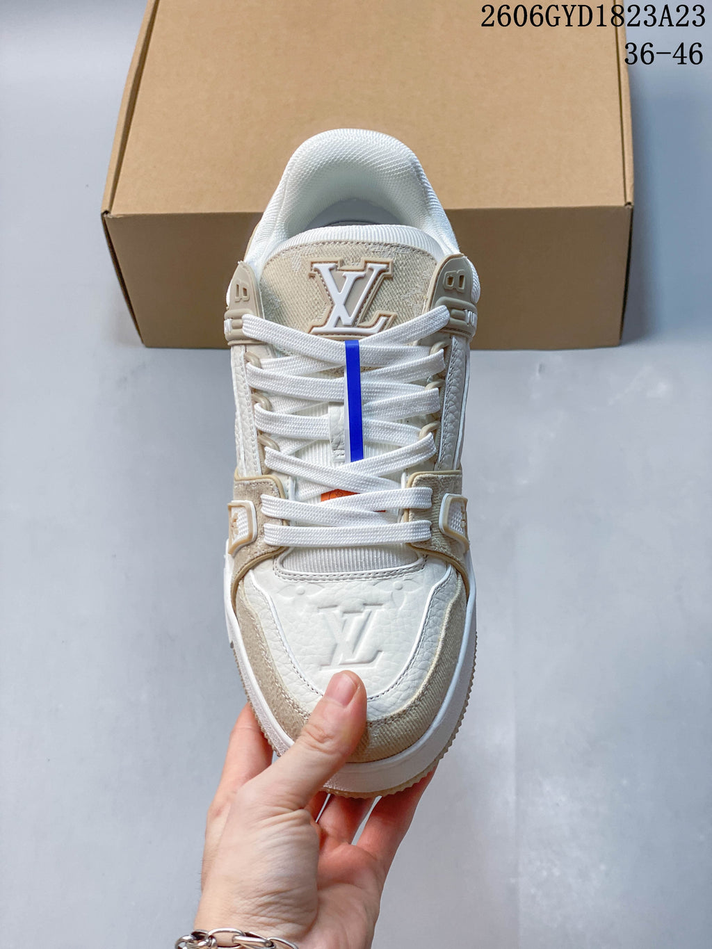 Front view showing the laces and layered panels of a Trainer Low sneaker