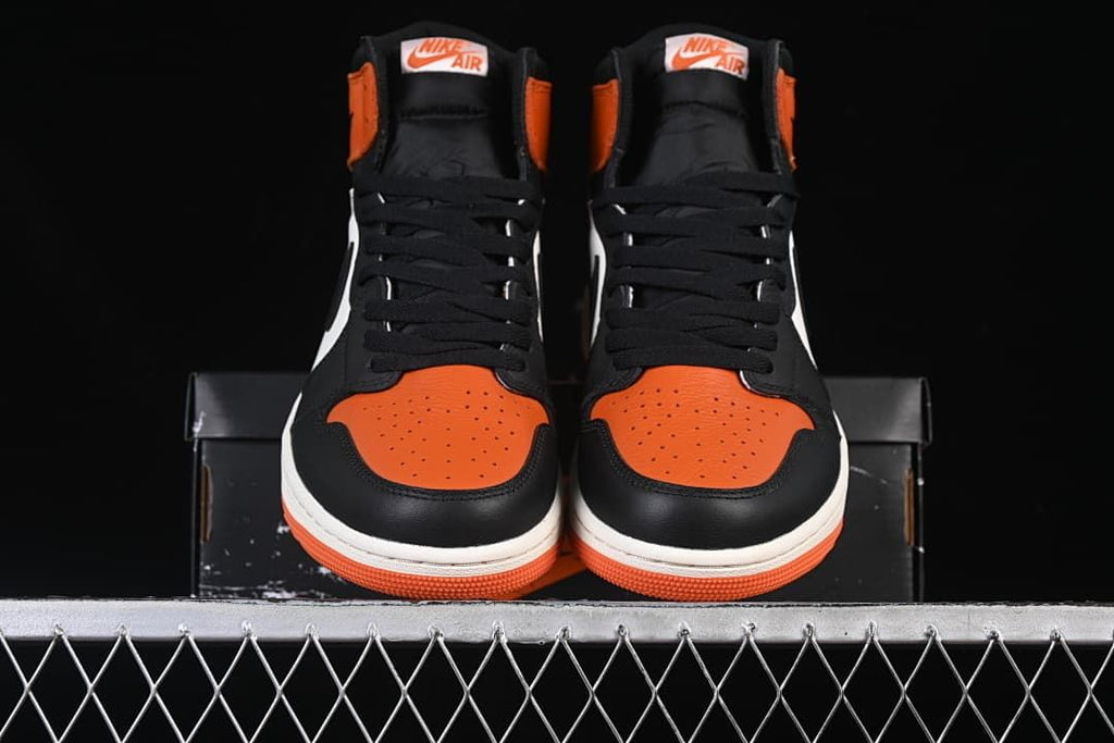 Front view of the pair with orange perforated toe panels