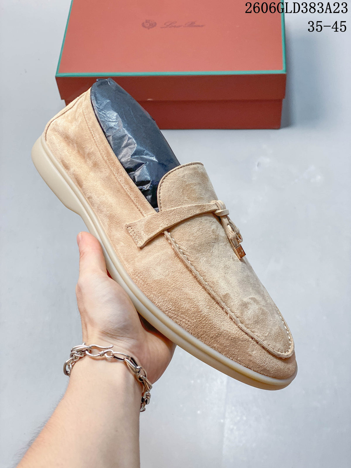 Side view of a light beige loafer showing its strap detail, moc-toe stitching, and light-colored sole; image also displays the size range 35–45.