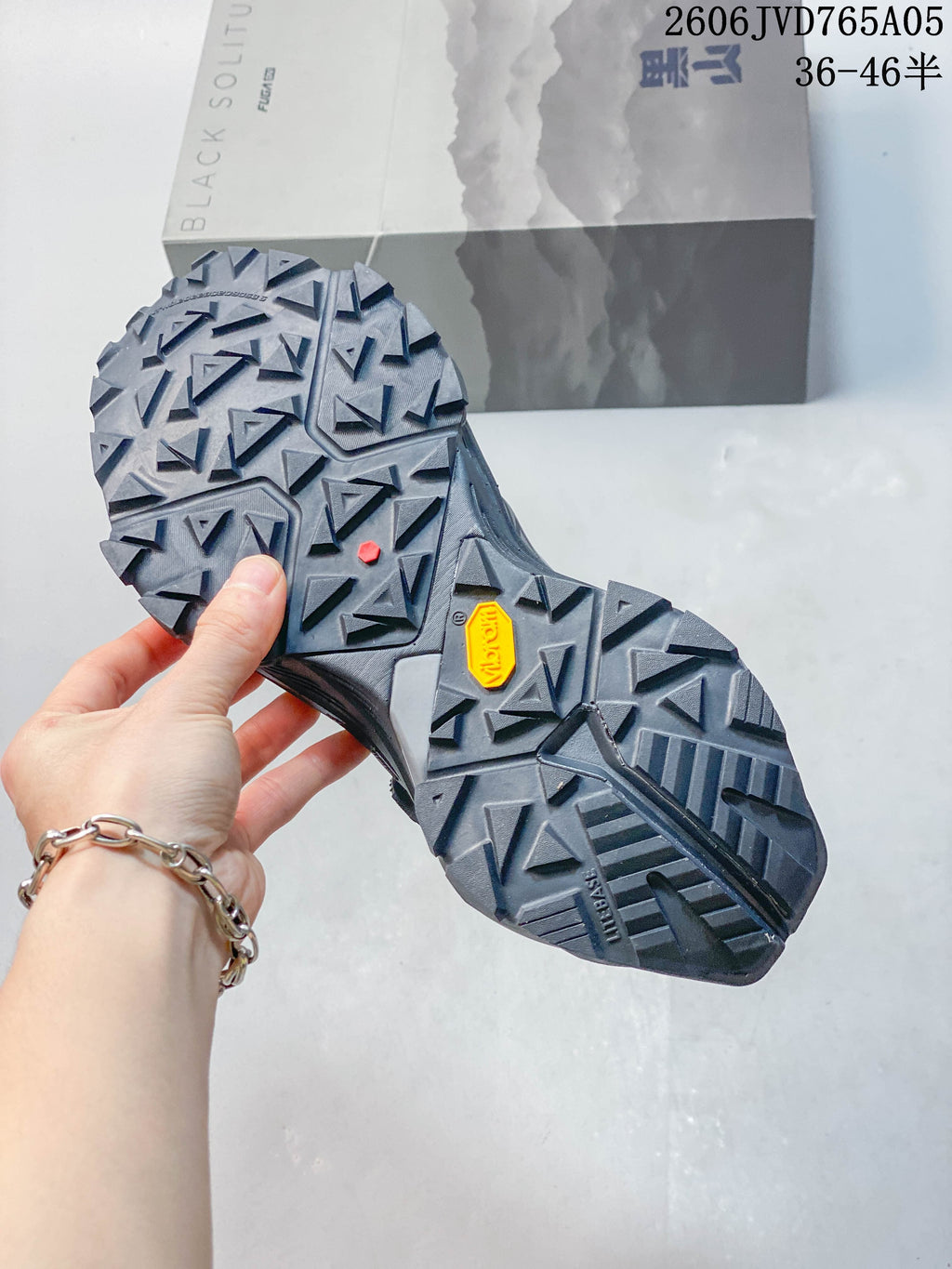 Close-up of the trail shoe outsole showing angular lugs and a Vibram mark.