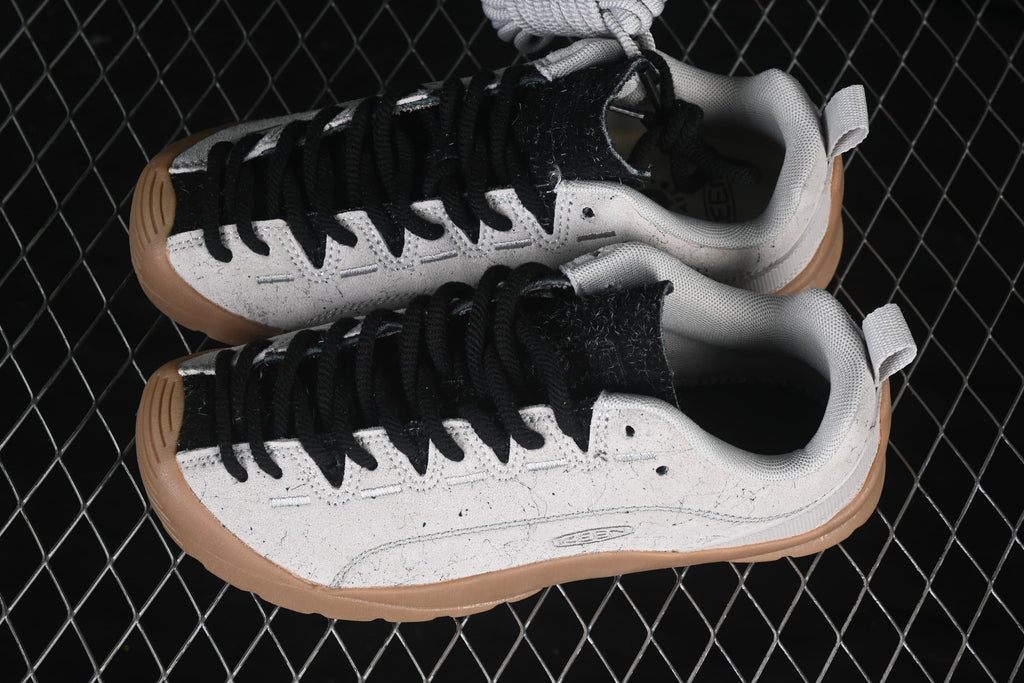 Overhead view of the pair, showing black laces, speckled light uppers, and gum-colored soles.
