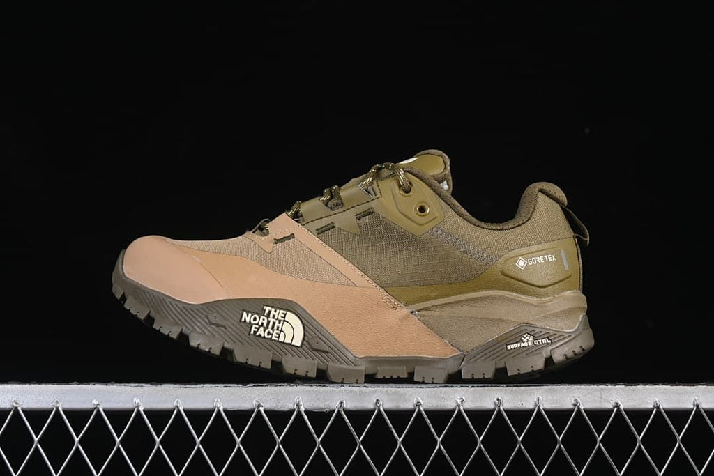 Side view of an olive-green and tan The North Face low-cut hiking shoe