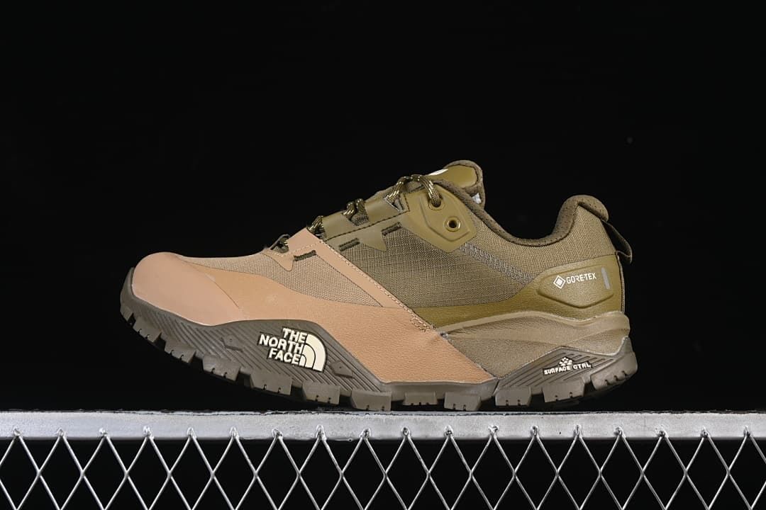 Side view of an olive-green and tan The North Face low-cut hiking shoe