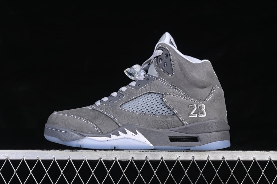 Side view of a grey and white Air Jordan 5 high-top sneaker