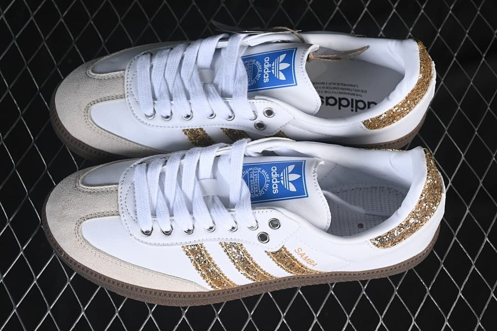 Pair of white and gold adidas Samba OG sneakers shown from above