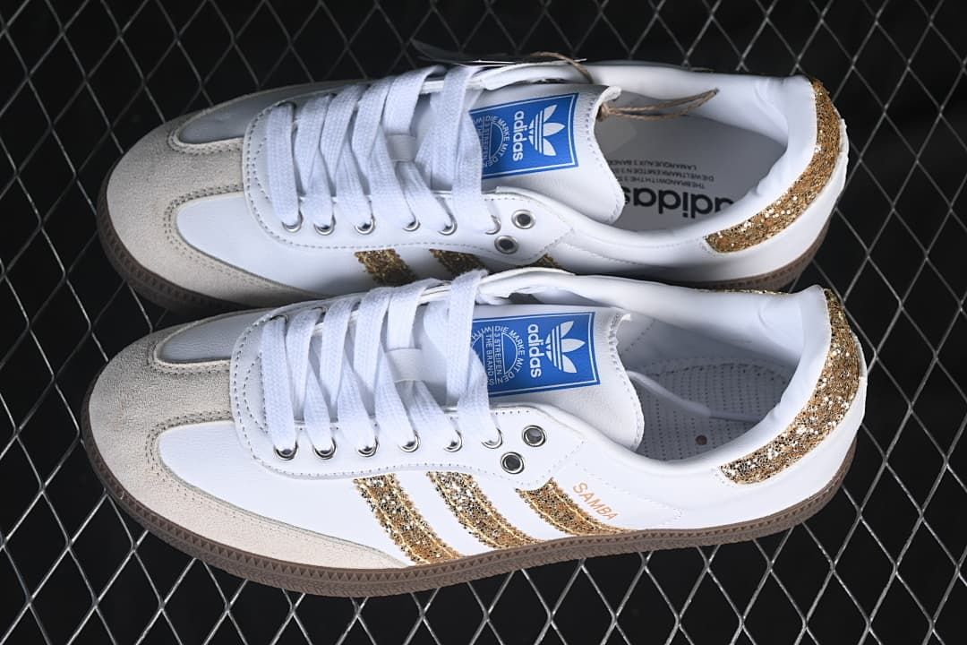 Pair of white and gold adidas Samba OG sneakers shown from above