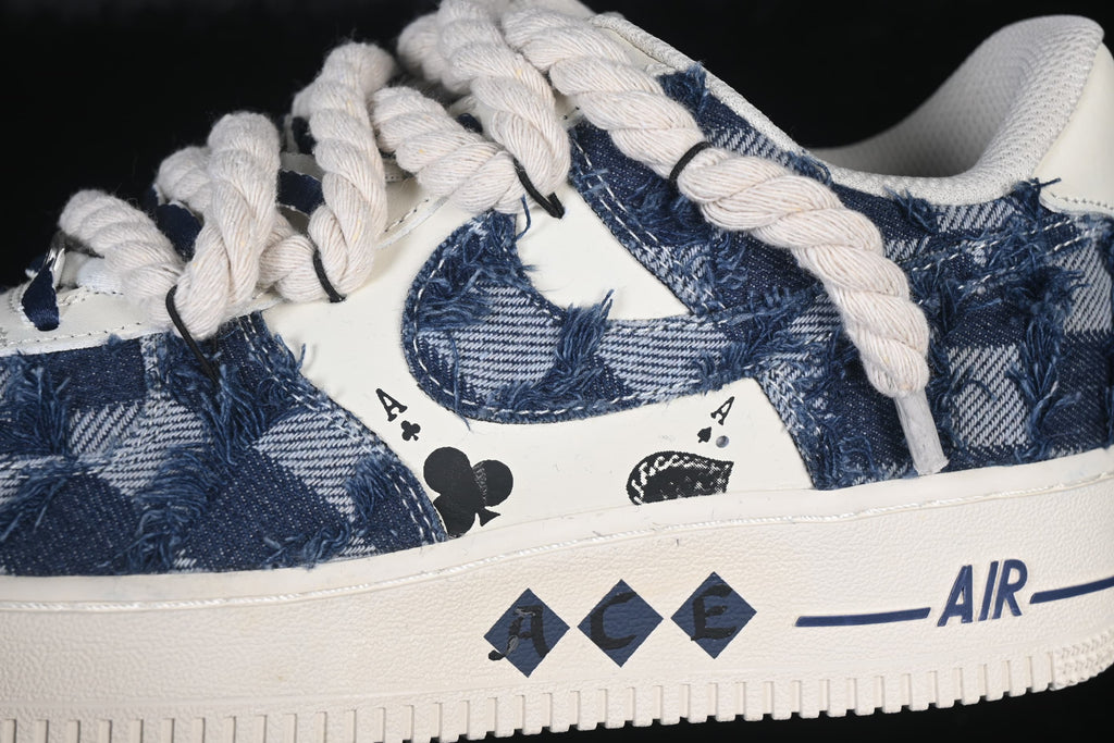Close-up of the blue distressed denim-style upper, rope laces, and ACE side graphics