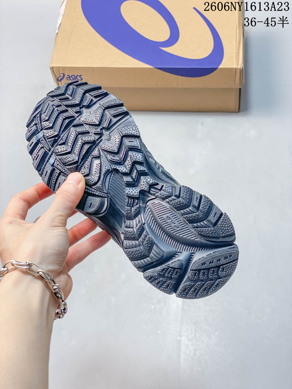 Close-up of the patterned outsole on an ASICS Gel-Kahana 8 FL sneaker