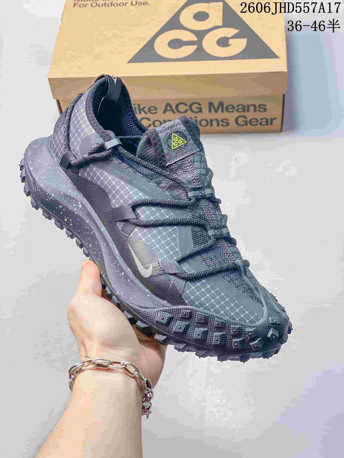 Nike ACG Mountain Fly sneaker in charcoal and gray with a white accent and chunky lugged outsole.