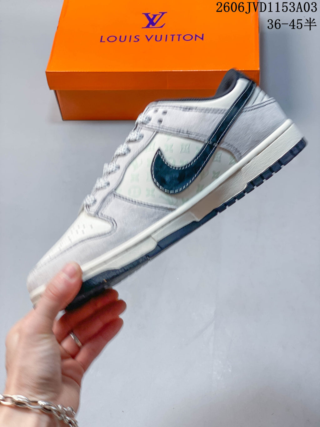 Side view of the low-top sneaker with patterned panels and navy swoosh