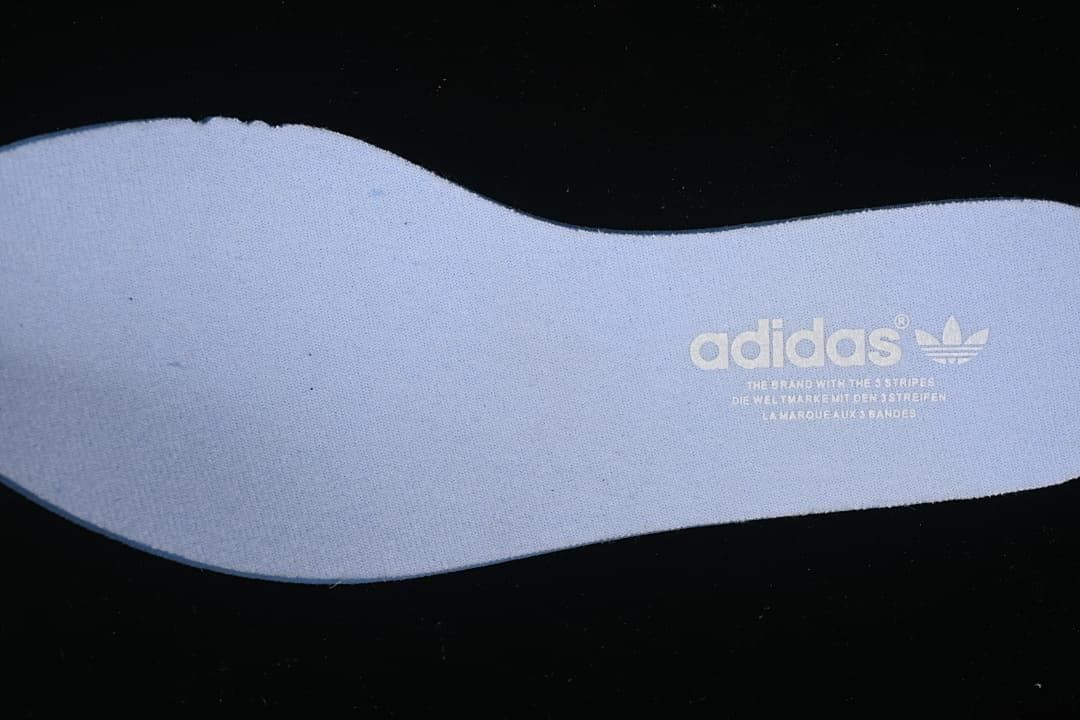 Close-up of a light blue insole with adidas branding
