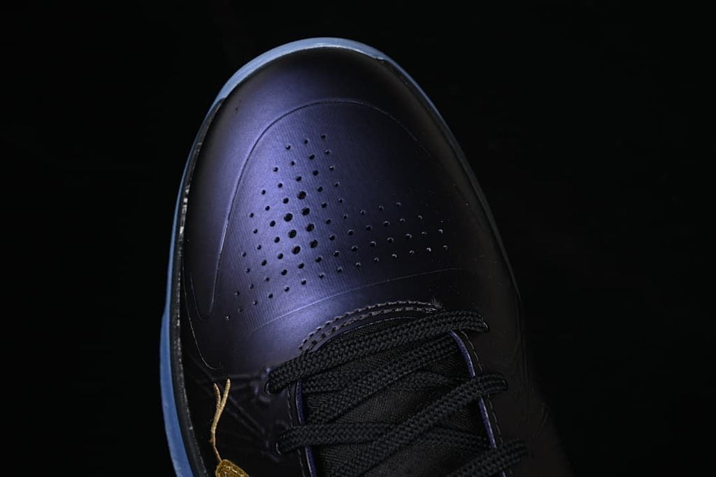 Top view of the perforated dark purple toe and black laces