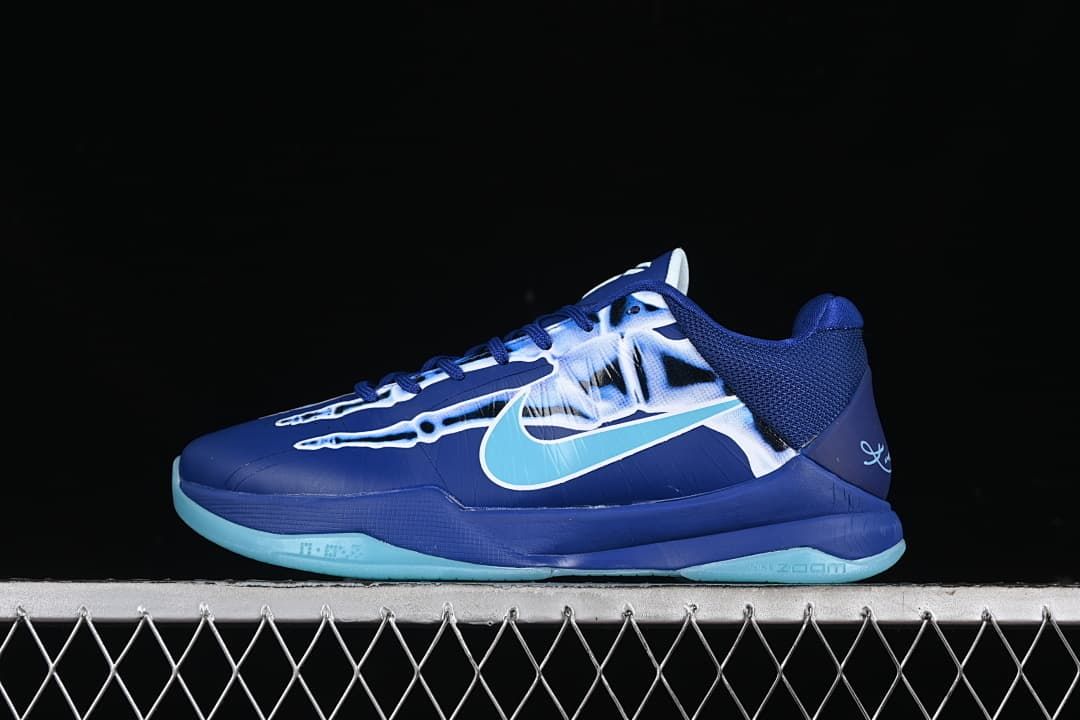 Side view of a deep blue basketball shoe with a skeletal graphic, aqua Swoosh, and aqua outsole