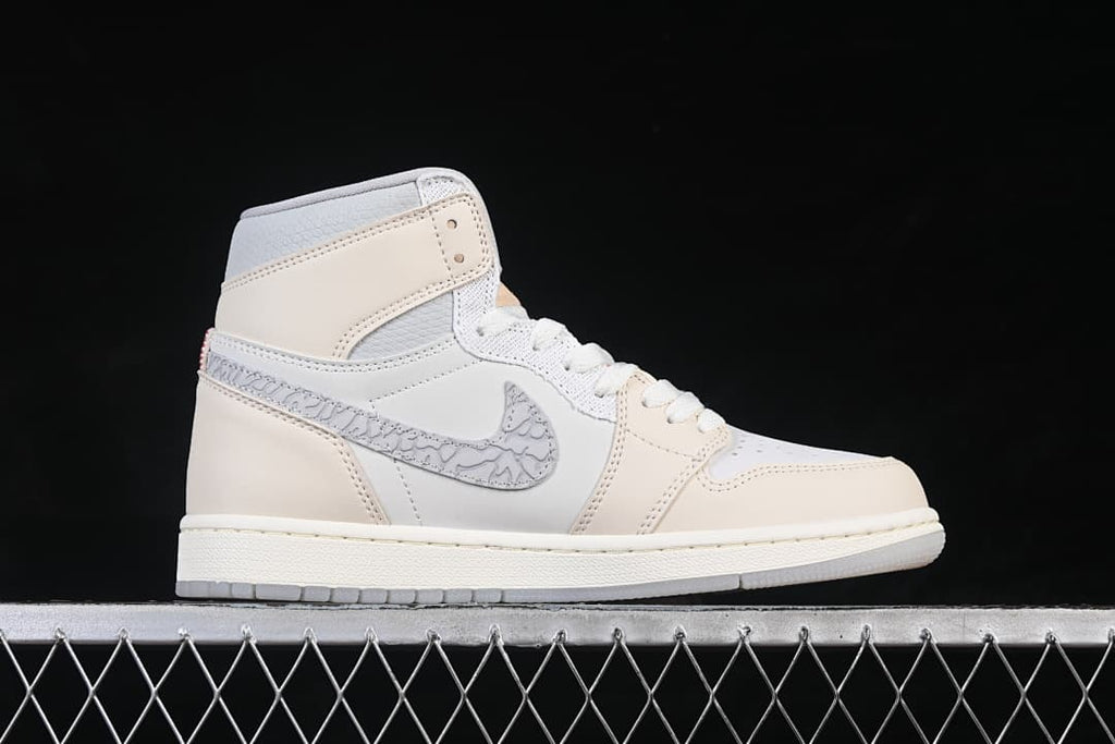 Side view of an ivory and white Air Jordan 1 High OG with patterned gray Swoosh