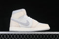 Side view of an ivory and white Air Jordan 1 High OG with patterned gray Swoosh