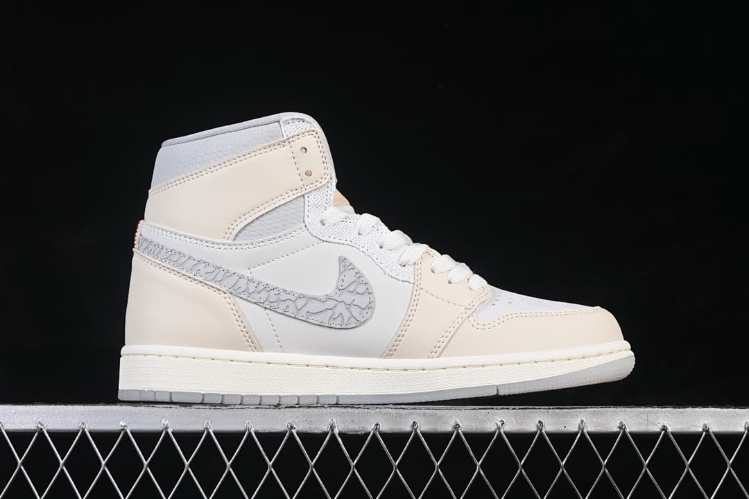Side view of an ivory and white Air Jordan 1 High OG with patterned gray Swoosh