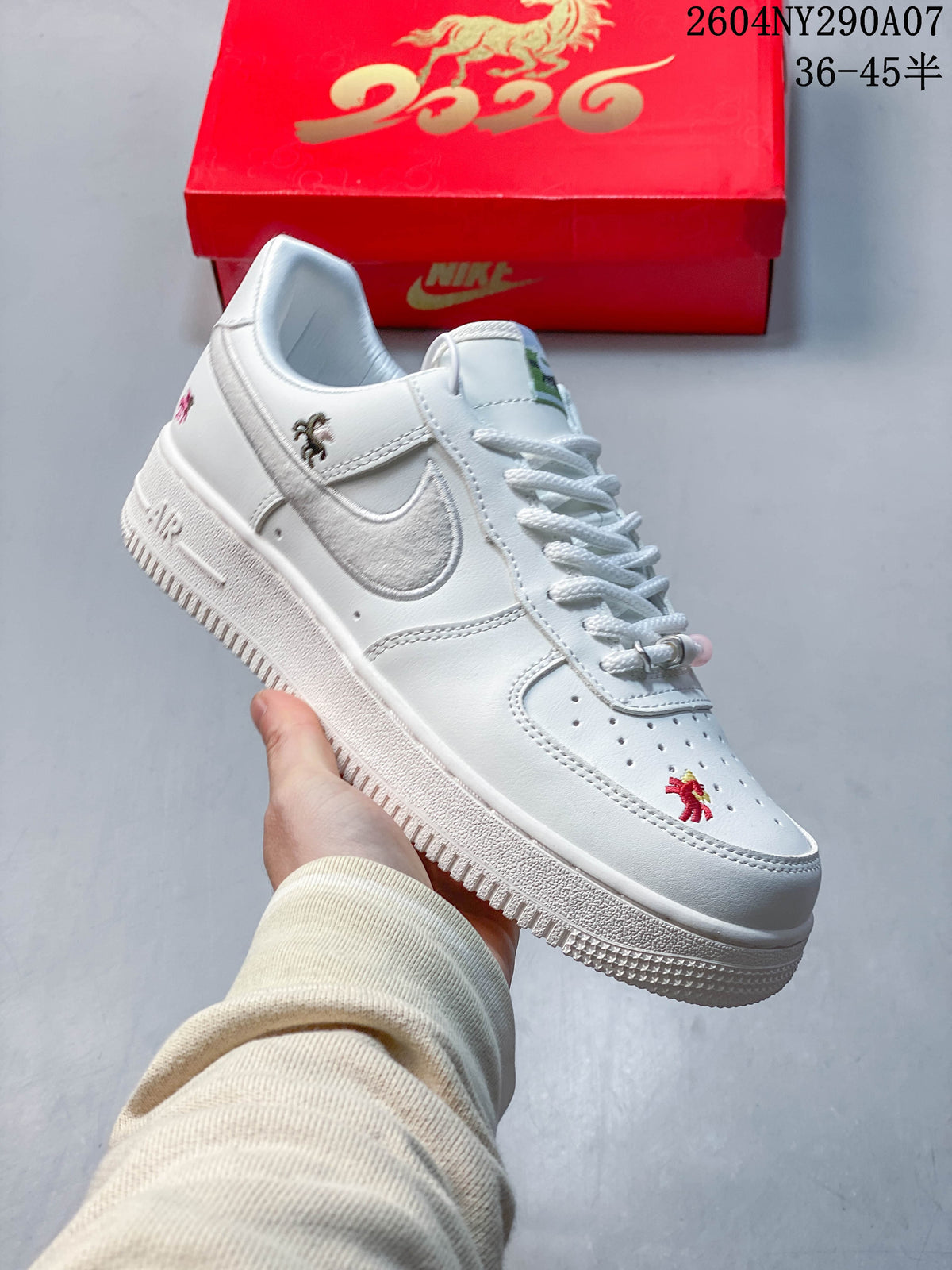 Angled side view of a white low-top sneaker with a silver side panel, white outsole and embroidered horse motifs.