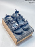 Pair of dark gray-black The North Face Explore Camp sandals displayed on a shoe box