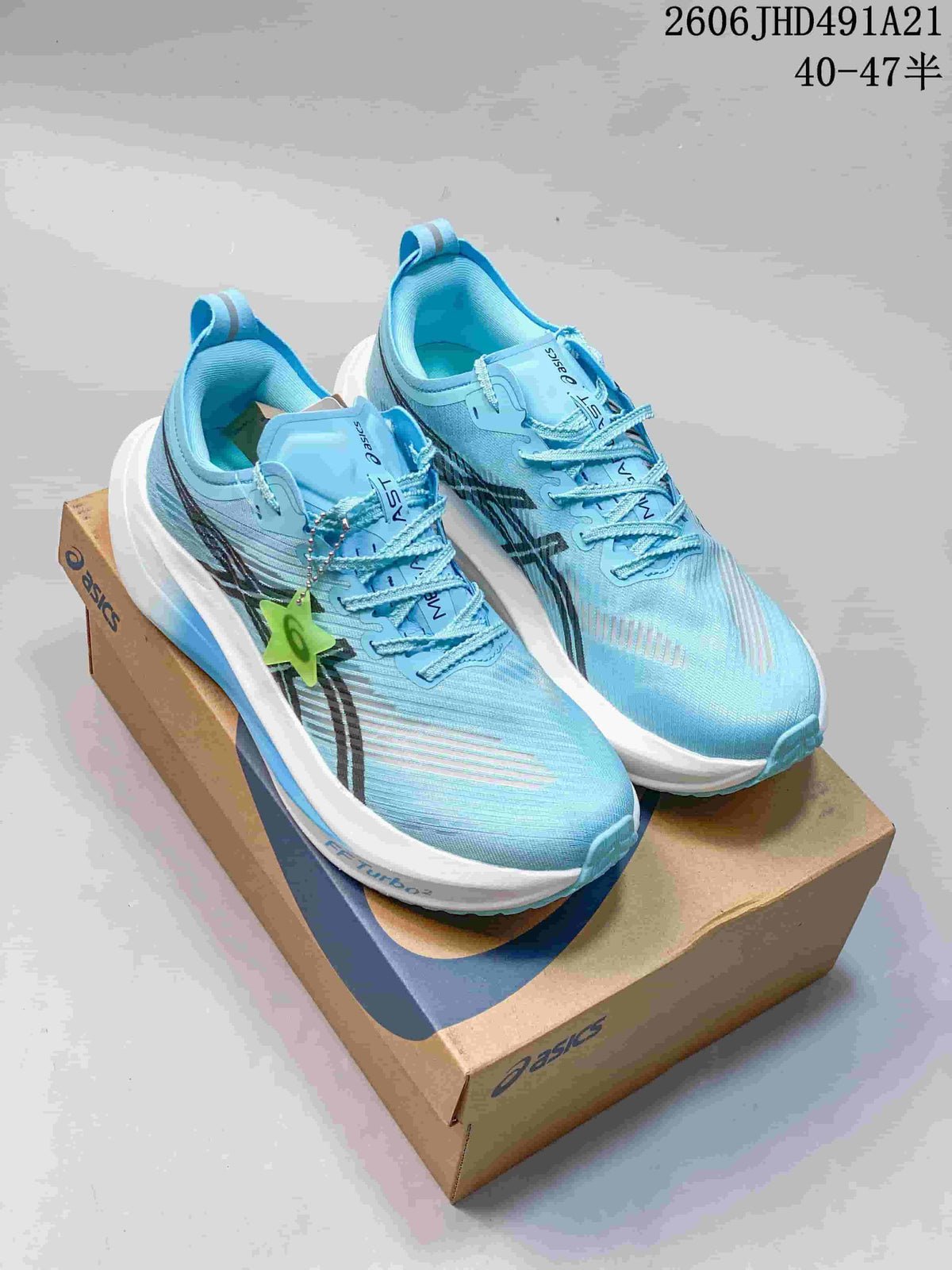 Pair of light blue ASICS MEGABLAST running shoes on a shoe box