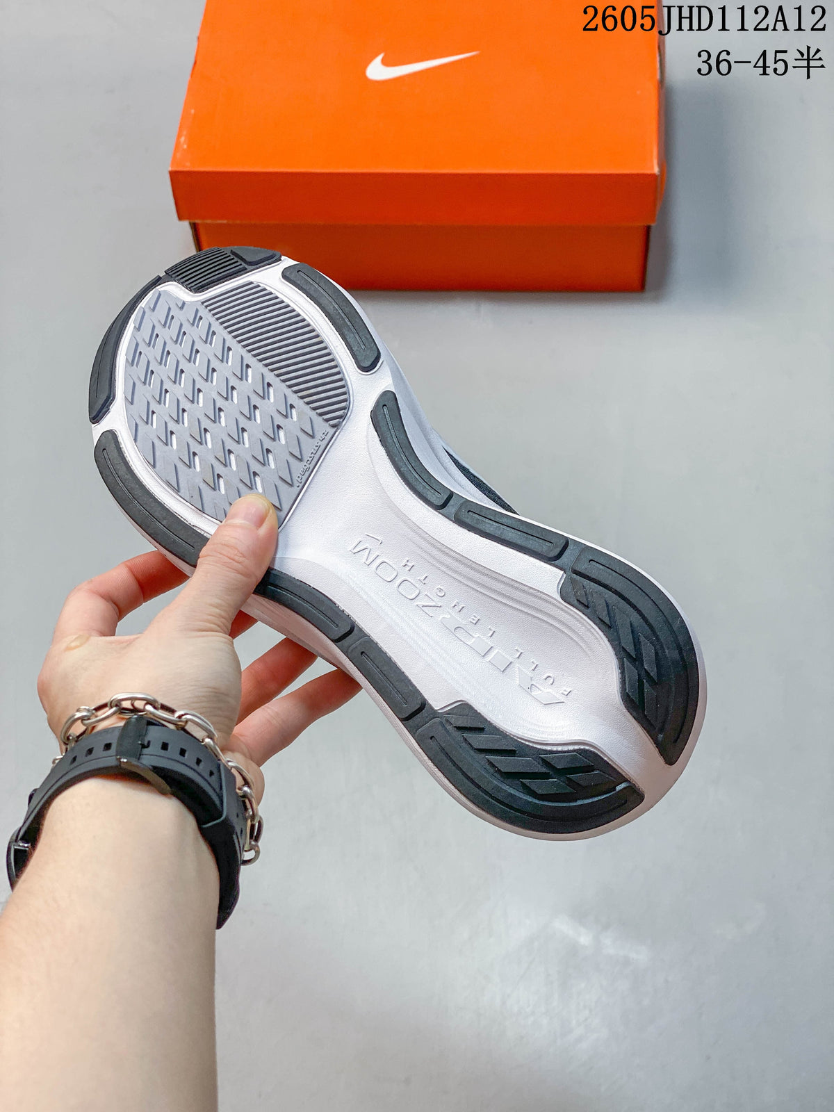 Close-up of the shoe outsole with dark tread sections and a light-colored center