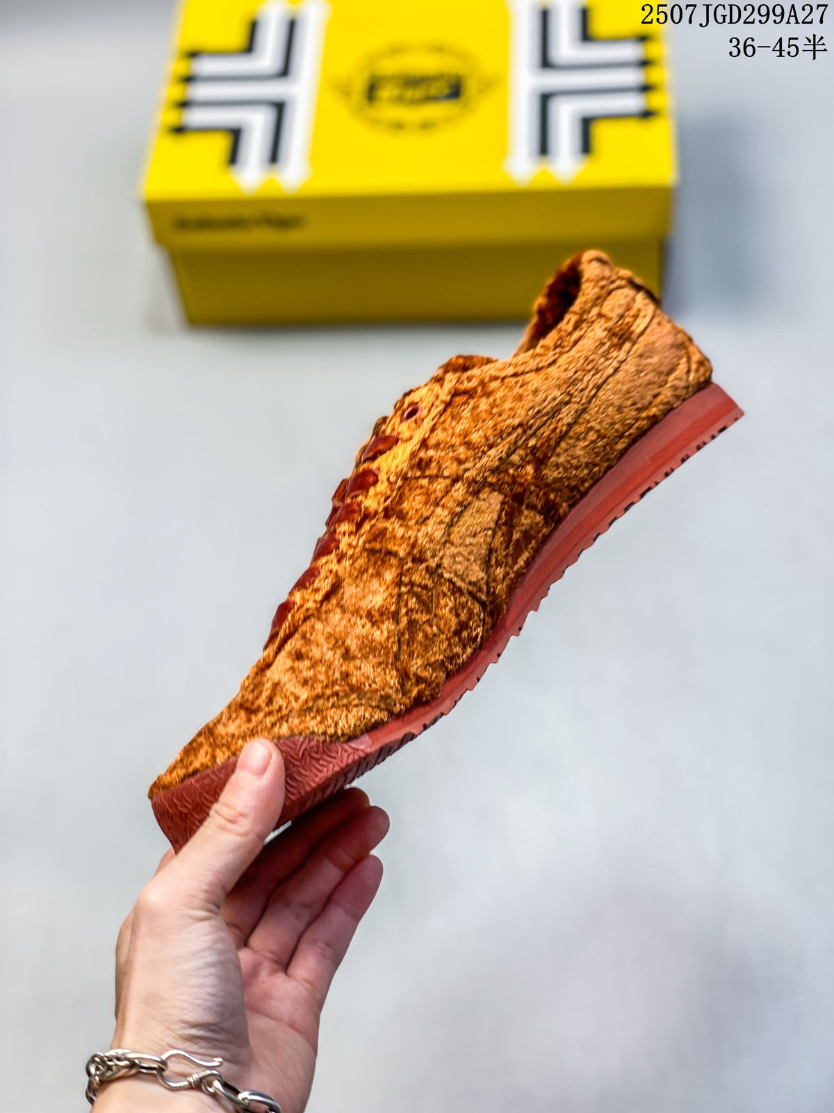 Side profile of the rust-brown sneaker showing its textured upper and brown sole