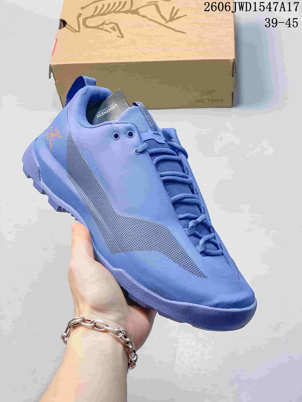 Angled side view of the blue Arc'teryx Konseal shoe