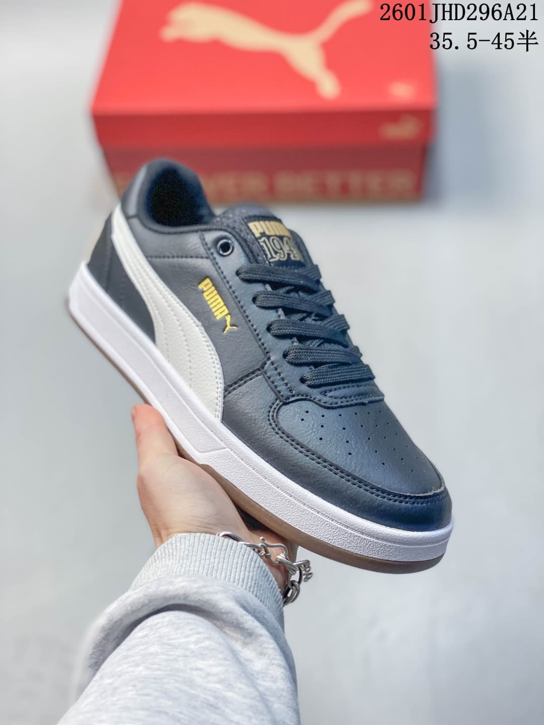 Angled side view of a navy PUMA Caven 2.0 Retro sneaker with a white side stripe