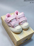 Pink Ocai sneakers with two hook-and-loop straps and chunky off-white soles, shown on a box.