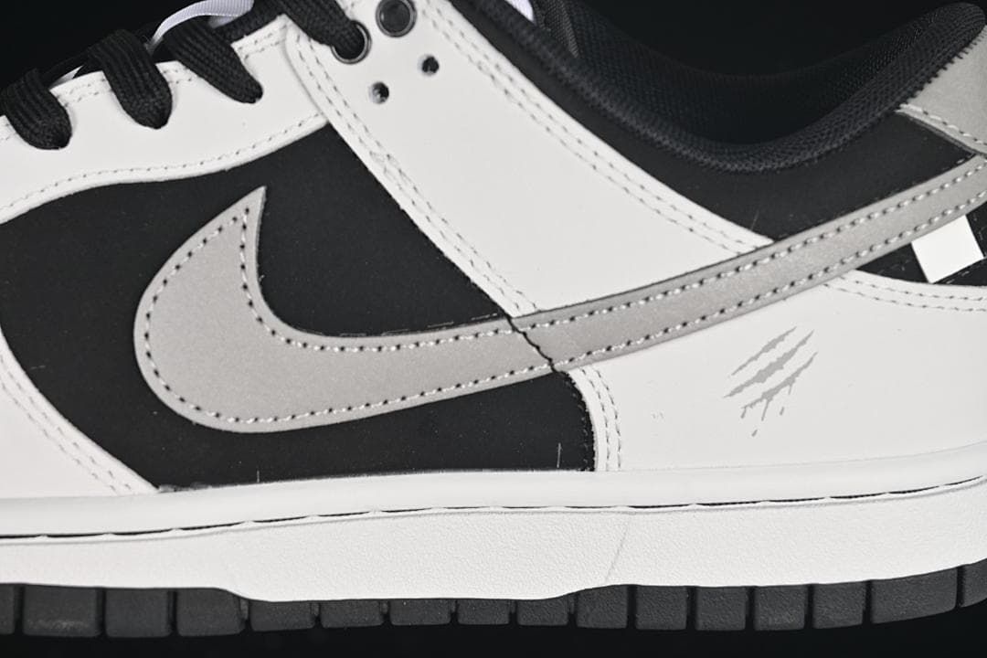 Close-up of the grey Swoosh and black and white side panels