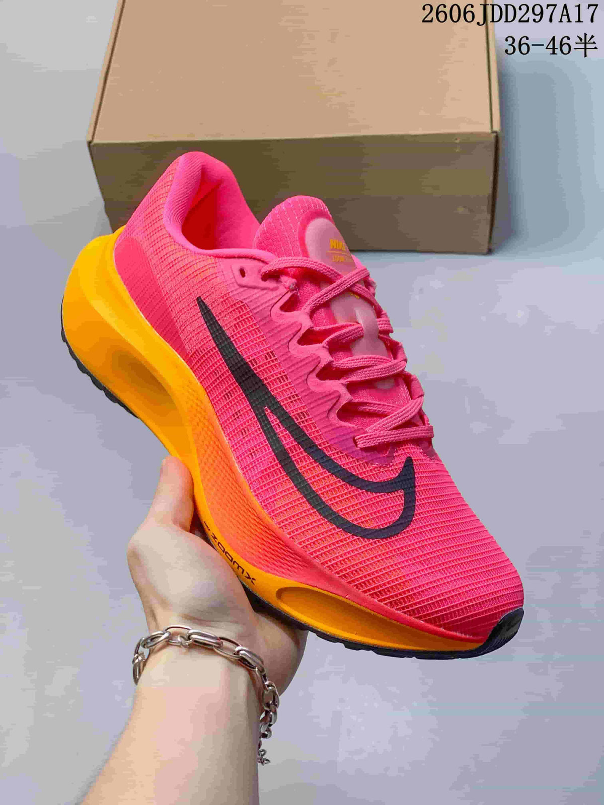 Close side view of a pink Nike Zoom Fly 5 with black Swoosh and orange midsole