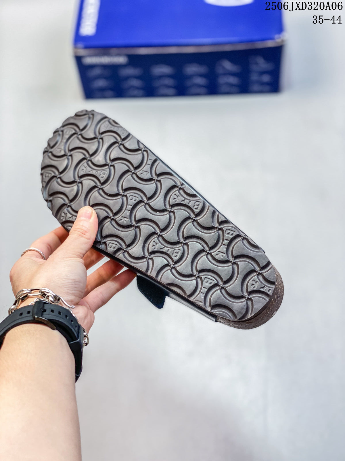 Close-up of the patterned outsole of a black clog; size range 35–44 is printed in the image.