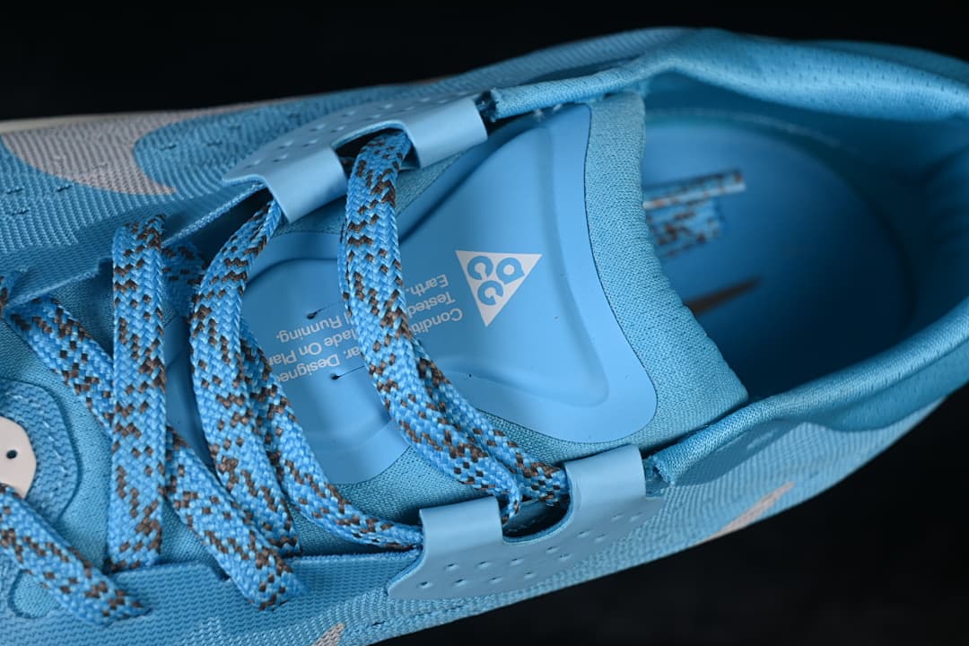 Top-down detail of the shoe opening, tongue and patterned laces.