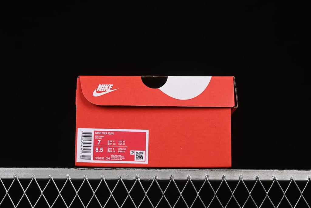 Red Nike shoe box with a V2K Run label and sample size information