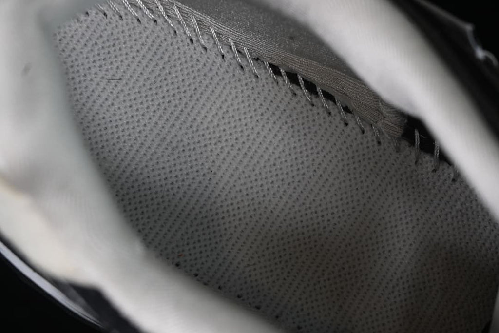 Close-up of the sneaker's perforated inner lining and stitching.