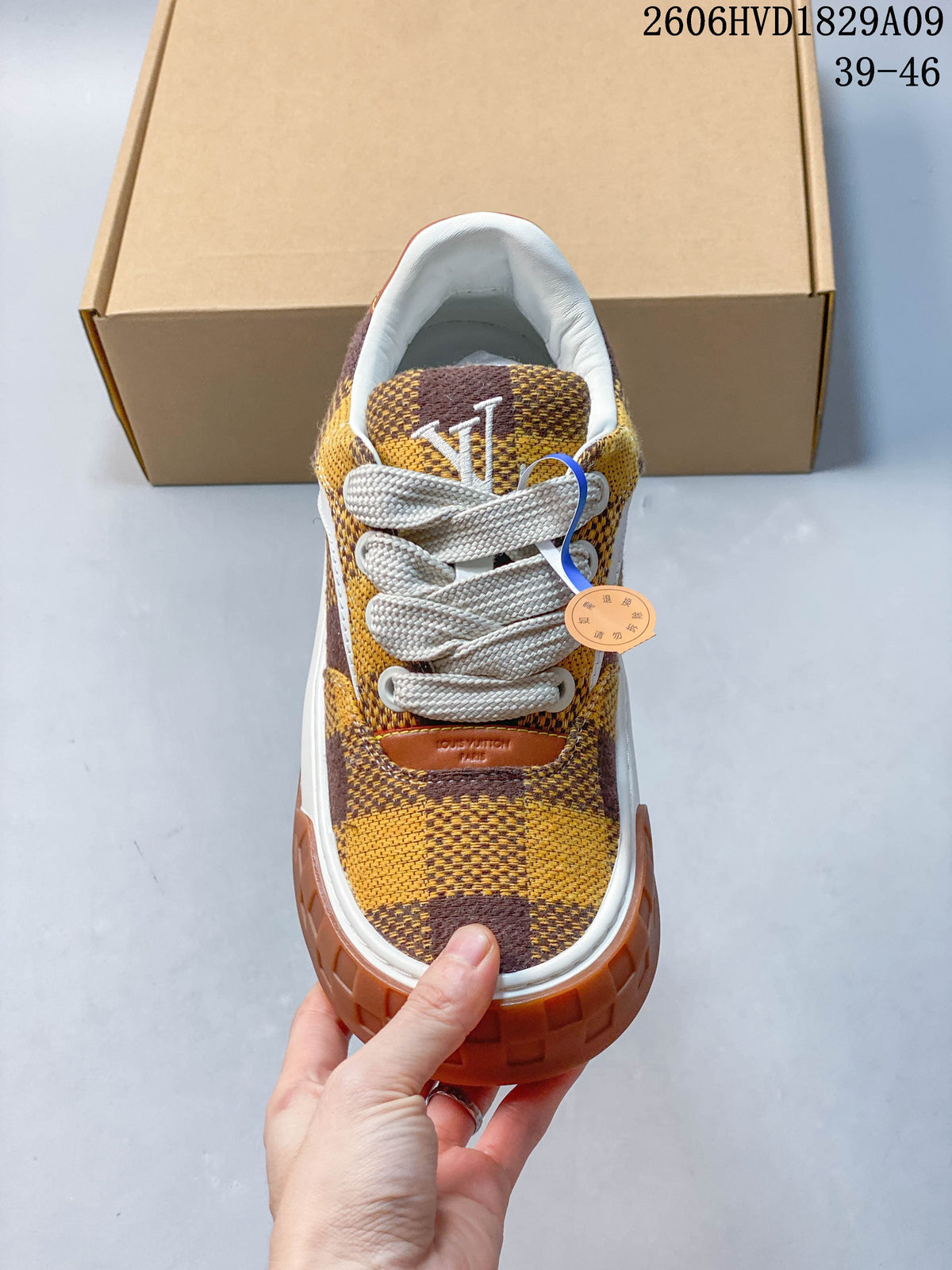 Front view highlighting the checkerboard upper, white laces, and brown toe bumper