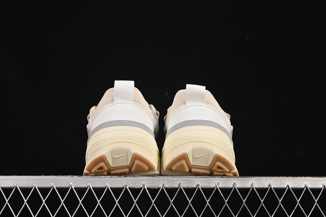 Rear view of both sneakers showing heel panels and outsole sections