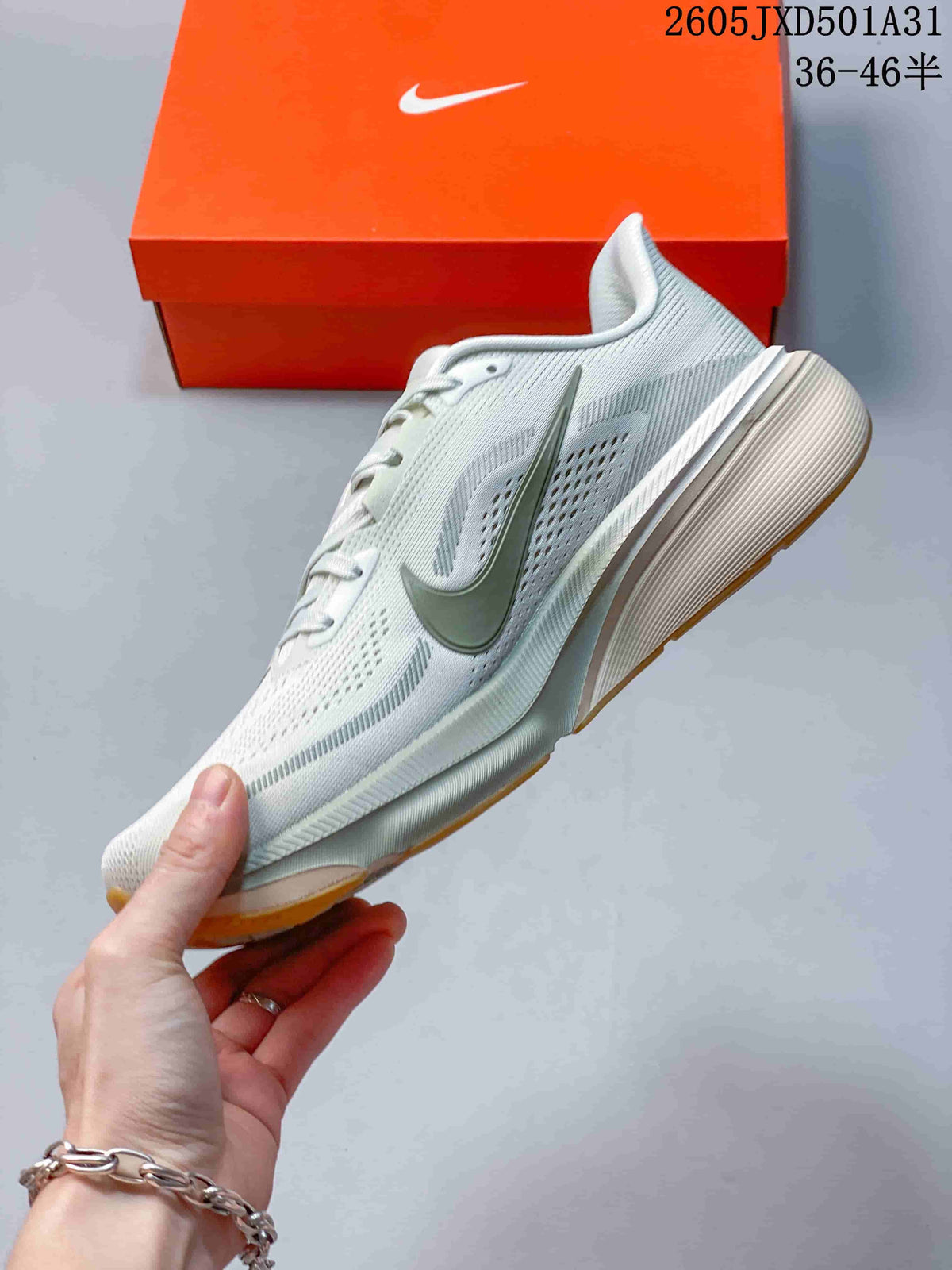 Side profile of a light-colored running shoe with a grey Swoosh and gum outsole accents