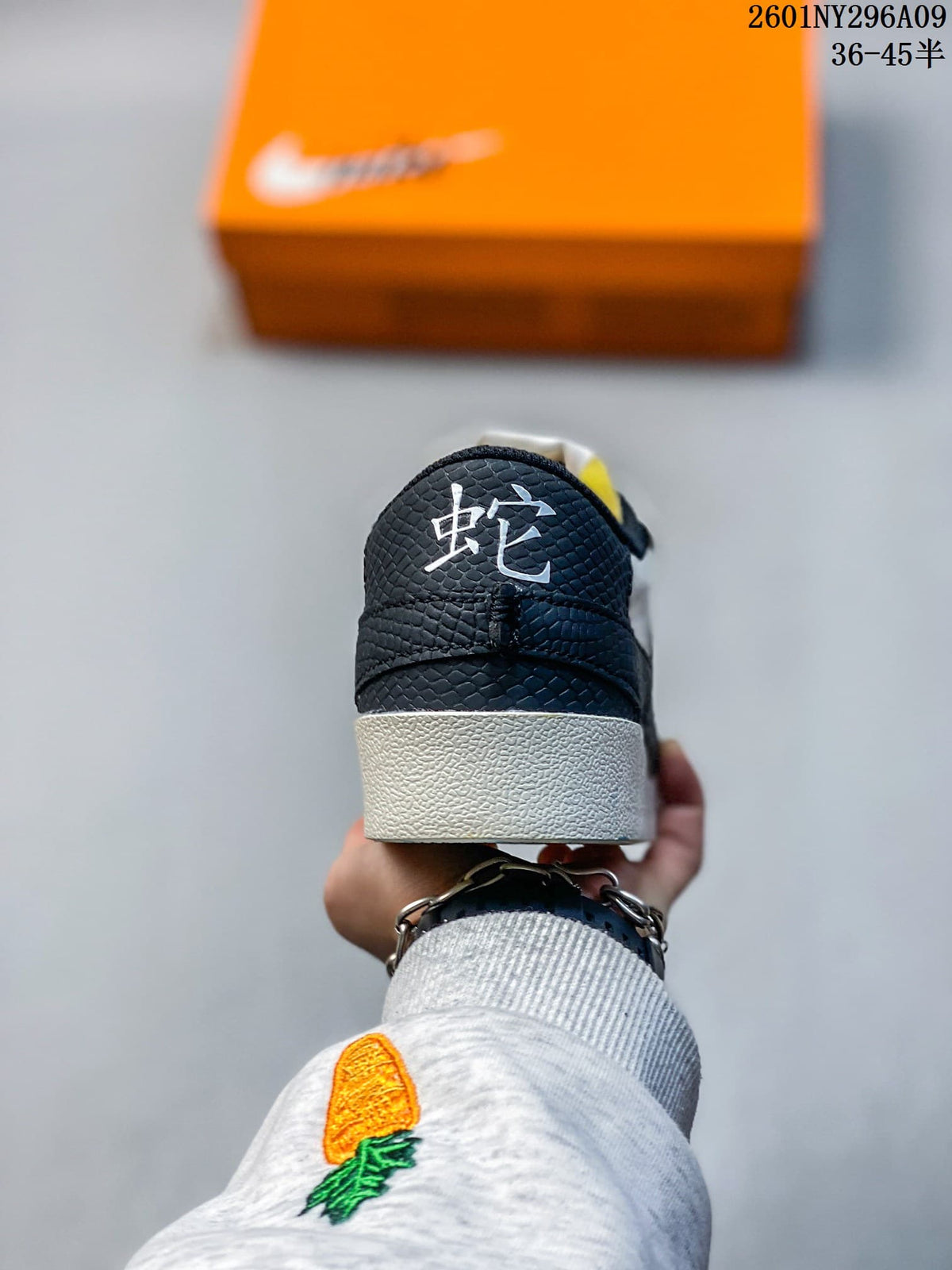 Rear view of the sneaker with a black textured heel panel and decorative character